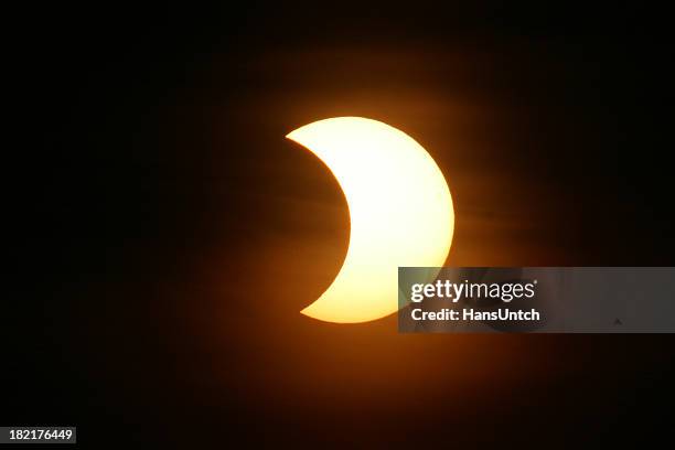 the nights sky with a partial solar eclipse - verduistering stockfoto's en -beelden