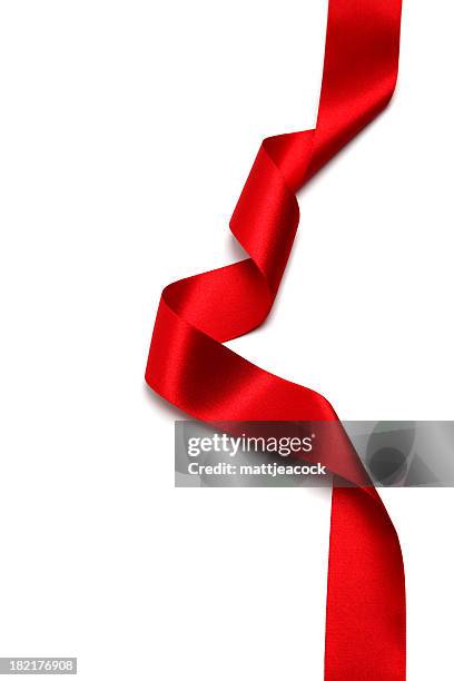 a long silk red ribbon against a white background - red satin fabric stock pictures, royalty-free photos & images