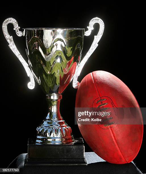 trophy and an afl ball - australian rules football ball stock pictures, royalty-free photos & images