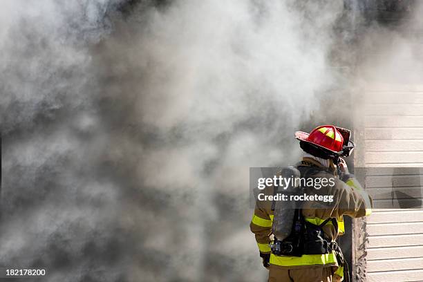 firefighter talking on radio - brandweerwagen stockfoto's en -beelden