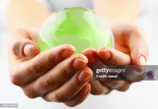 globe in the palm - world at your fingertips stockfoto's en -beelden