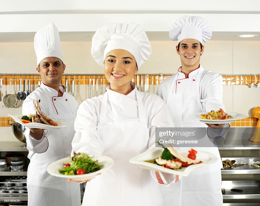 Three young chefs in kitchen