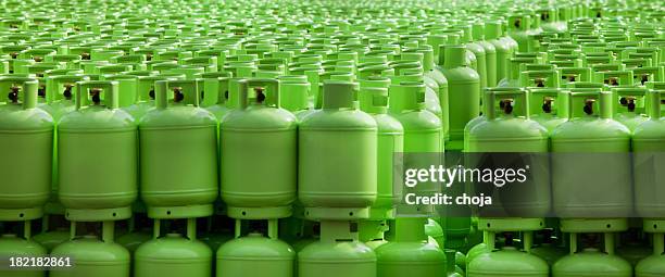 storage of butane gas cylinders - green cylinder stock pictures, royalty-free photos & images