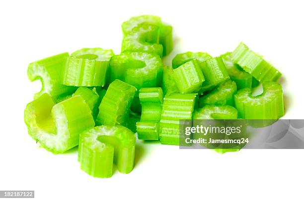 pile of chopped celery isolated on white background - selderij stockfoto's en -beelden