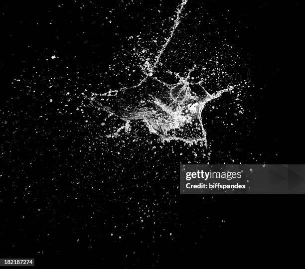 a high speed image of a water splash on black - black background stock pictures, royalty-free photos & images