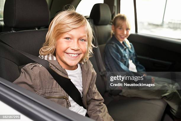 boy and girl smiling while sitting in a car - blonde hair boy stock pictures, royalty-free photos & images