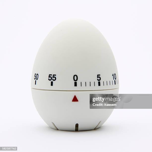 white egg-shaped kitchen timer isolated on white background - timer stock pictures, royalty-free photos & images