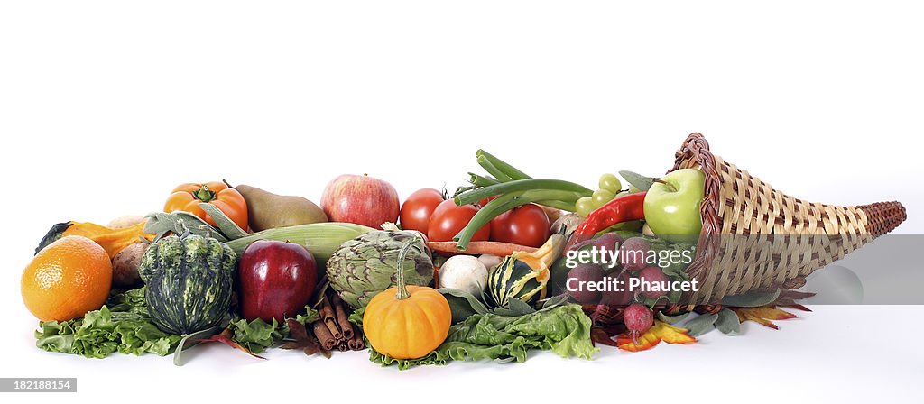 Cornucopia with fresh fruits and vegetables isolated on white