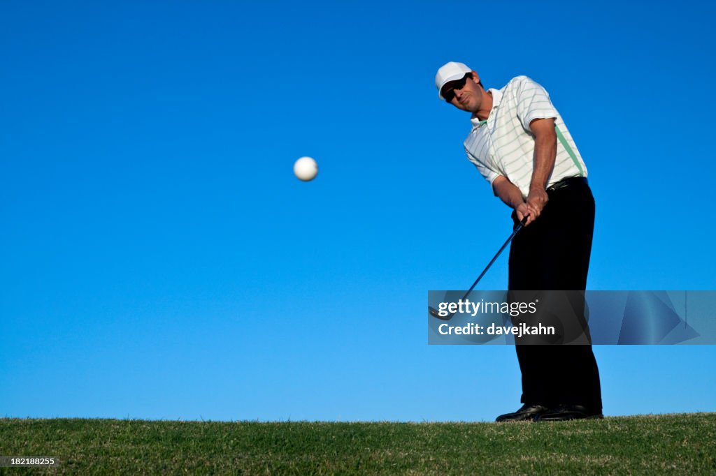 Male Golfer Chipping with Ball