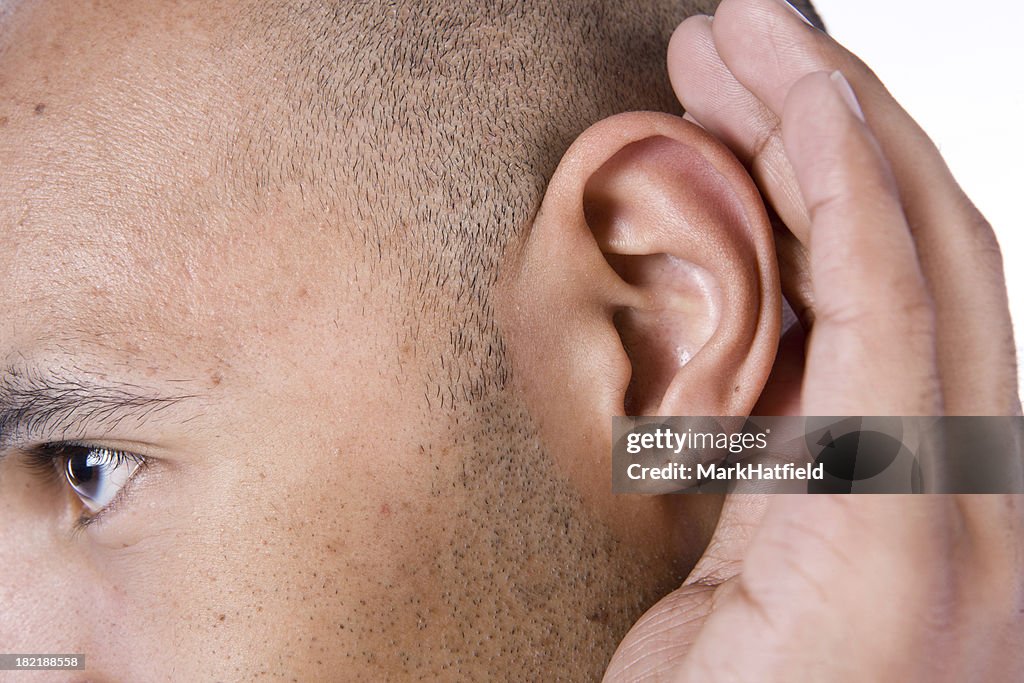 Man Cups His Ear To Improve Listening