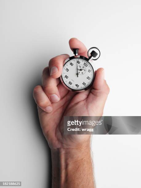 holding a stopwatch - tijdmeter stockfoto's en -beelden