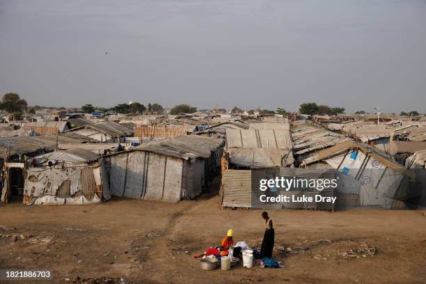 Women wash clothes in an Internally Displaced Persons camp on November 30, 2023 in Bentiu, South Sudan. Climate change has divided South Sudan into...