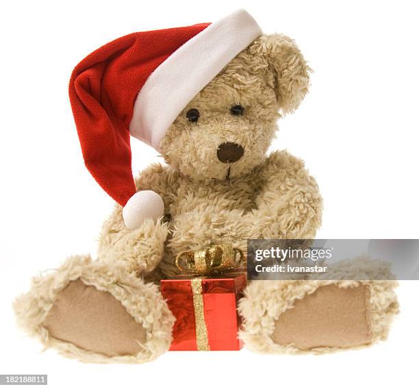 teddy bear opening christmas gift - teddybear stock pictures, royalty-free photos & images