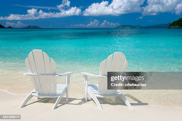 white chairs on the caribbean beach - adirondack chair stock pictures, royalty-free photos & images