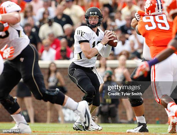 Tanner Price of the Wake Forest Demon Deacons drops back to pass during the game against the Clemson Tigers at Memorial Stadium on September 28, 2013...