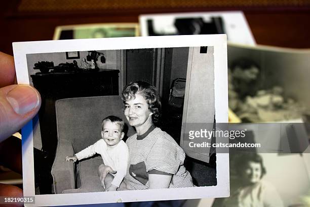 hand holds vintage photograph of mother and child - photography bildbanksfoton och bilder