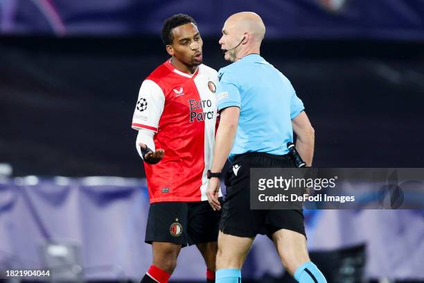 Quinten Timber of Feyenoord Rotterdam and referee Anthony Taylor during the UEFA Champions League match between Feyenoord and Atletico Madrid at...