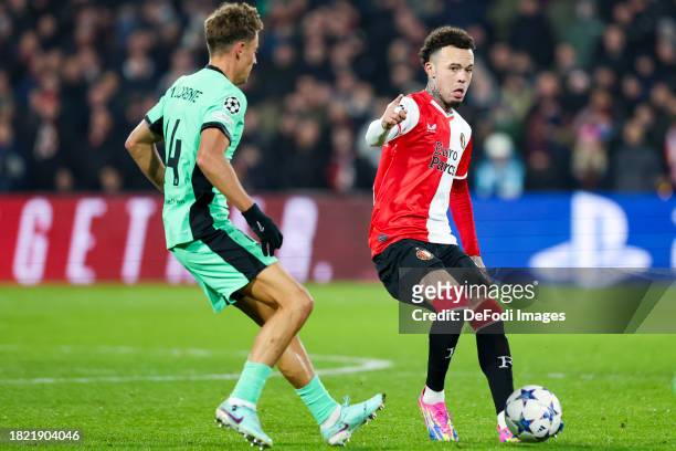 Quilindschy Hartman of Feyenoord Rotterdam and Marcos Llorente of Atletico Madrid battle for the ball during the UEFA Champions League match between...