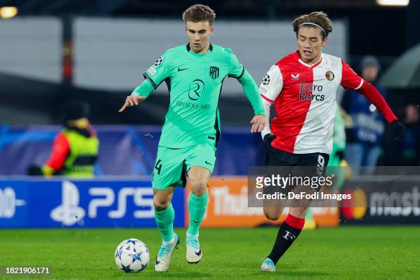 Pablo Barrios of Atletico Madrid and Ayase Ueda of Feyenoord Rotterdam battle for the ball during the UEFA Champions League match between Feyenoord...