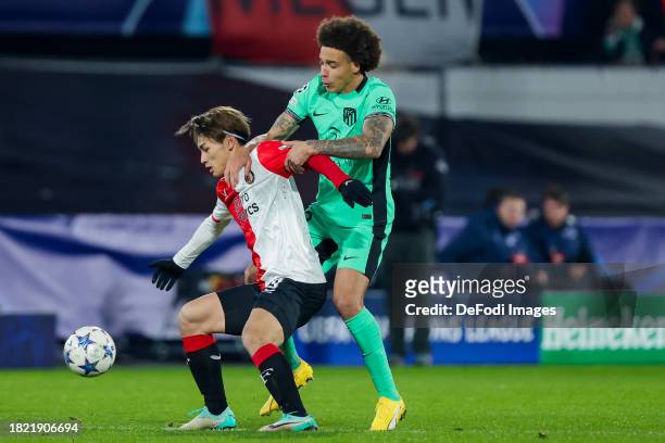 Ayase Ueda of Feyenoord Rotterdam and, Axel Witsel of Atletico Madrid battle for the ball during the UEFA Champions League match between Feyenoord...