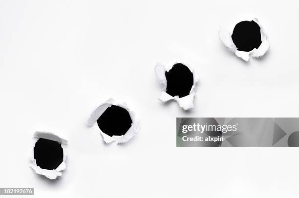 holes in paper - bullet holes stockfoto's en -beelden