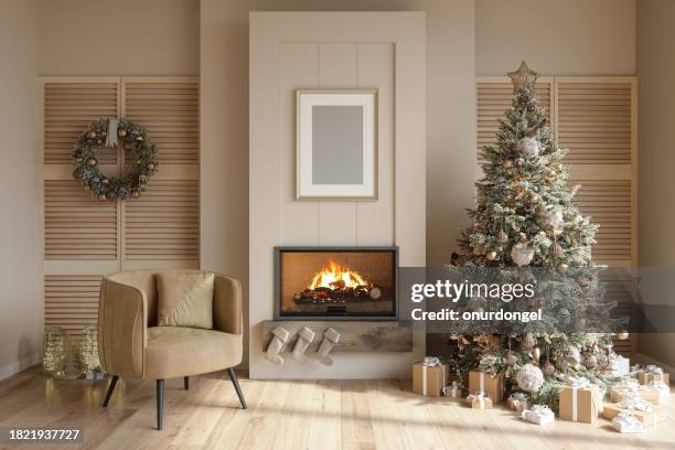 modern living room interior with christmas tree, ornaments, gift boxes, fireplace and armchair - cosy christmas stock pictures, royalty-free photos & images