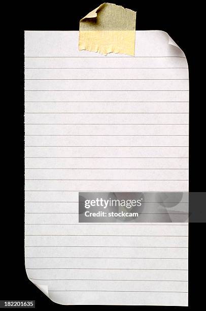 sheet of lined blank note paper on black - ripped lined paper stock pictures, royalty-free photos & images