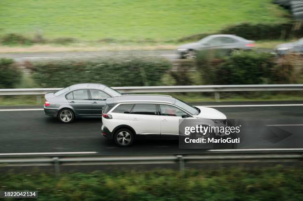 car overtaking on a highway - overtaking stock pictures, royalty-free photos & images