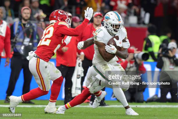 Trent McDUFFIE of Kansas City Chiefs and Raheem Mostert of Miami Dolphins compete for the ball during the NFL match between Miami Dolphins and Kansas...