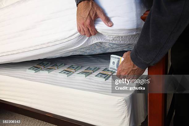 hiding money under the mattress - hiding money stock pictures, royalty-free photos & images