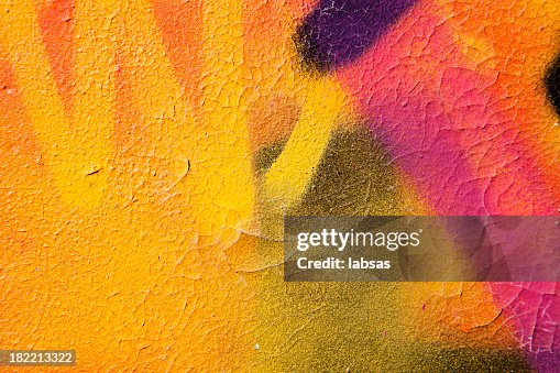 Colorful graffiti over a cracked surface Colorful graffiti over a cracked surface