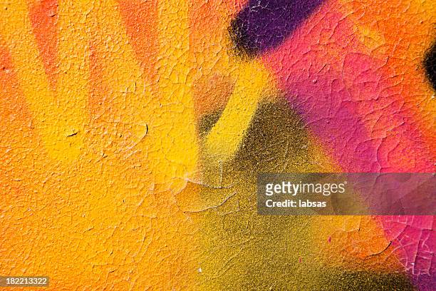 colorful graffiti over a cracked surface - color image stockfoto's en -beelden