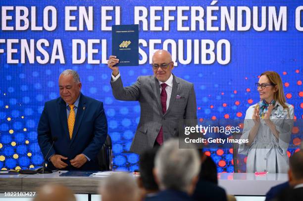 President of the National Assembly Jorge Rodriguez shows the referendum notification act during a press conference on the day after Venezuelans voted...