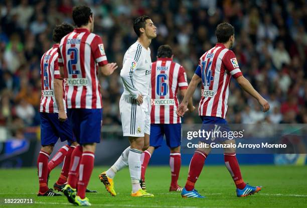 Cristiano Ronaldo of Real Madrid CF reacts after failing to score surrounded by Atletico de Madrid players during the La Liga match between Real...