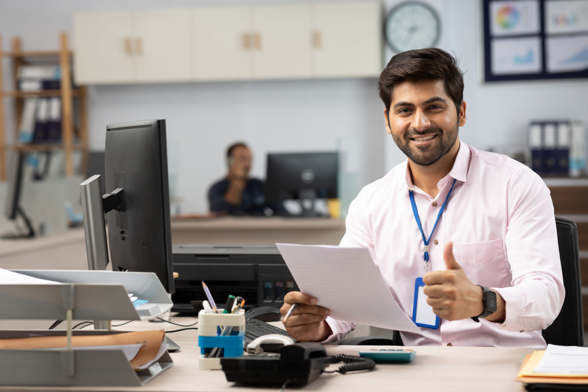 Businessman with Computer Reading Documents in Office stock photo Businessman with Computer Reading Documents in Office stock photo