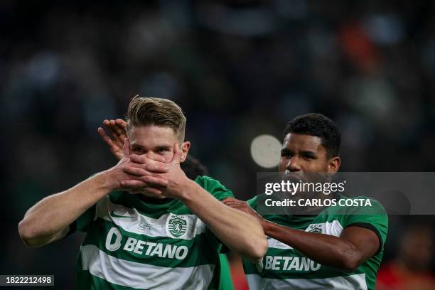 Sporting Lisbon's Swedish forward Viktor Gyokeres celebrates with Sporting Lisbon's Brazilian defender Matheus Reis after scoring his team's second...