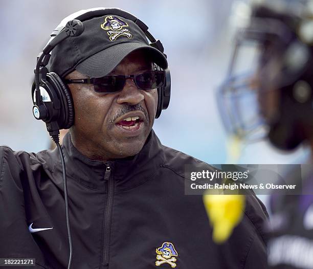 East Carolina coach Ruffin McNeill talks with his players on the sideline during the second quarter against North Carolina at Kenan Stadium in Chapel...