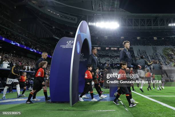 Mastercard Player Mascots escort SSC Napoli and Real Madrid CF players prior to start the UEFA Champions League match between Real Madrid and SSC...