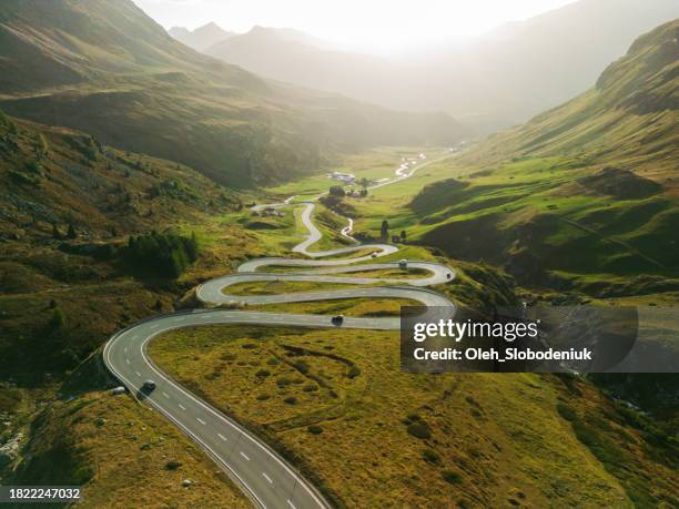 aerial view of  serpentine road in swiss alps  in autumn - mountain road stock pictures, royalty-free photos & images