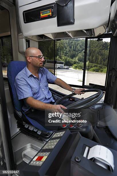 a bus driver in a blue shirt looking at the road - bus driver stock pictures, royalty-free photos & images