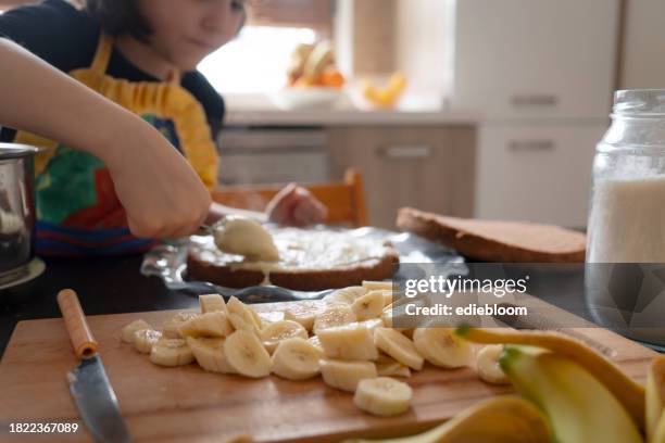 little girl preparing cake - banana cream cake stock pictures, royalty-free photos & images