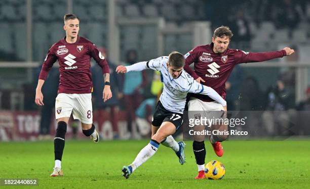 Charles De Ketelaere of Atalanta BC battles for the ball with Karol Linetty of Torino FC and Ivan Ilic of Torino FC during the Serie A TIM match...