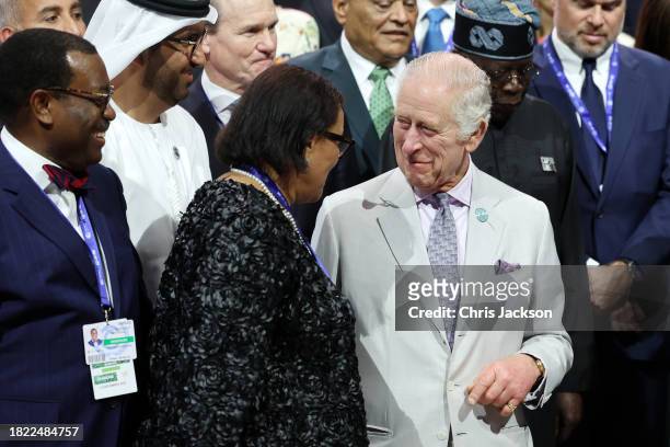 King Charles III and The Baroness Scotland of Asthal Patricia Scotland share a moment during a group picture at the Business and Philanthropy Climate...