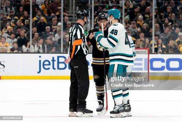 Boston Bruins right wing David Pastrnak and San Jose Sharks center Tomas Hertl speak with referee Dan O'Rourke during a game between the Boston...