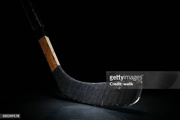 hockey stick - hockey player black background stock pictures, royalty-free photos & images