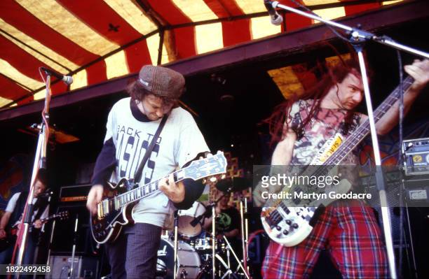 Mark Chadwick and Jeremy Cunningham of The Levellers perform on stage at the Deptford Urban Free Festival, Fordham Park, London, July 1993.