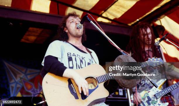 Mark Chadwick and Jeremy Cunningham of The Levellers perform on stage at the Deptford Urban Free Festival, Fordham Park, London, July 1993.