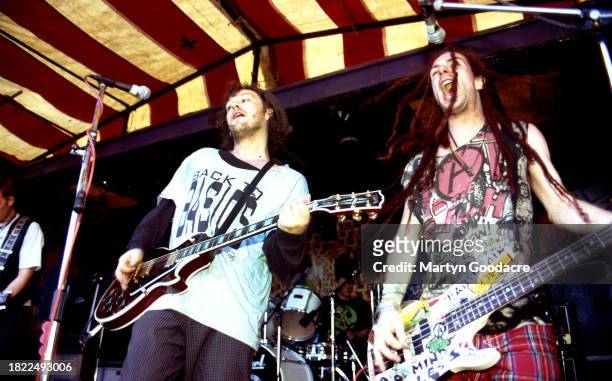 Mark Chadwick and Jeremy Cunningham of The Levellers perform on stage at the Deptford Urban Free Festival, Fordham Park, London, July 1993.