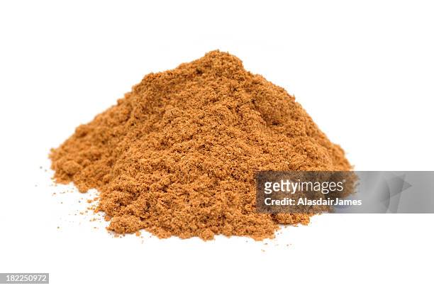 pile of ground cinnamon on white background - cassia bark stock pictures, royalty-free photos & images