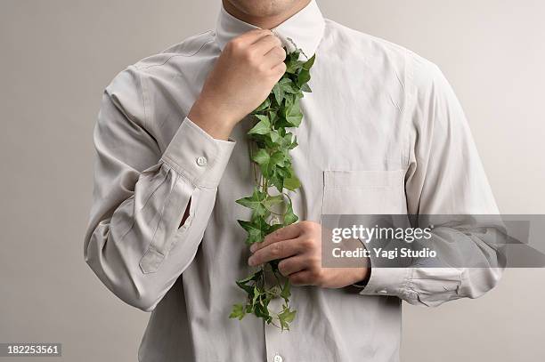 man to tie the use of green - green shirt stock pictures, royalty-free photos & images